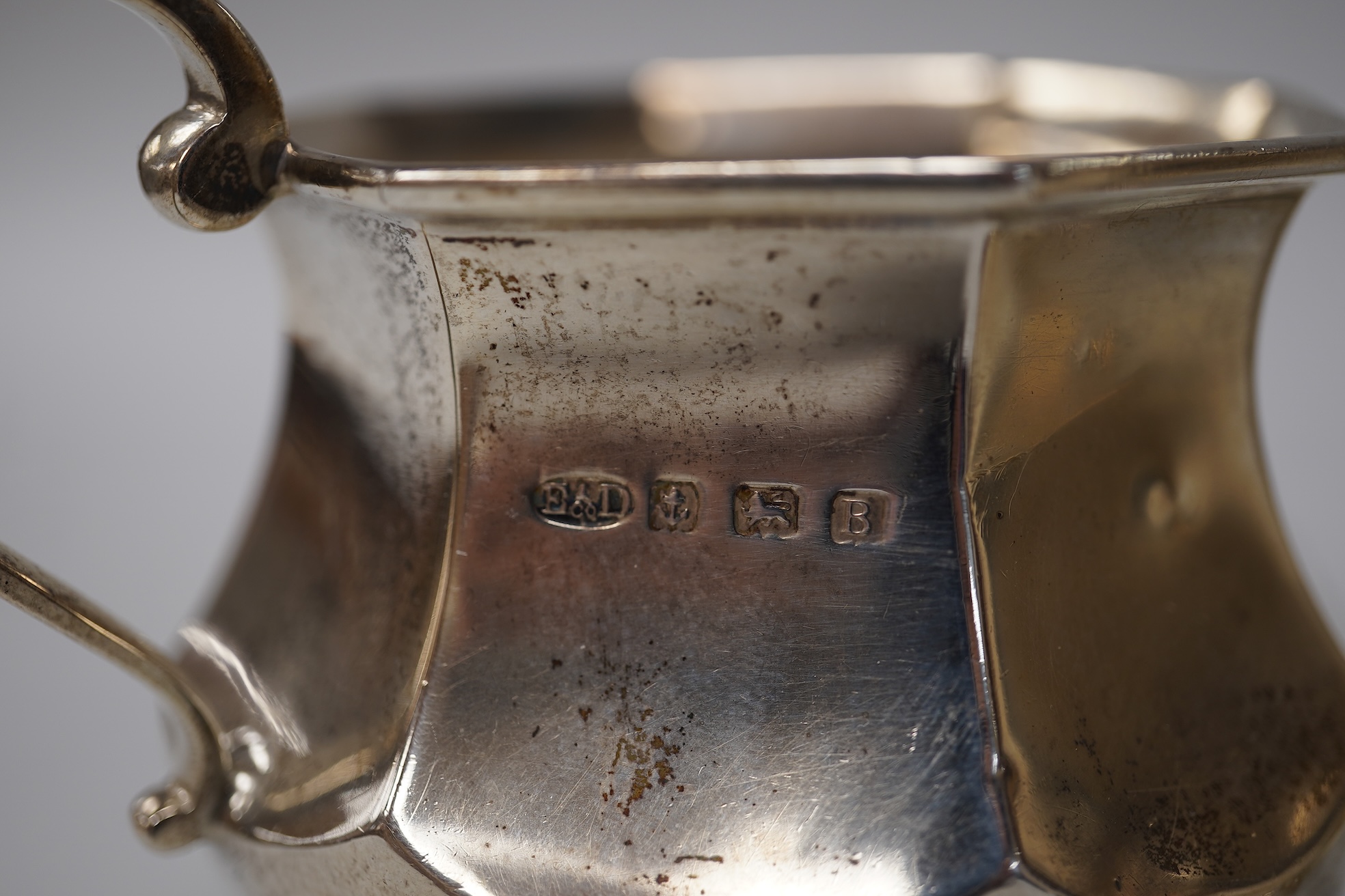 A George V silver christening mug, George Howson, Sheffield, 1934, height 77mm, together with one other silver mug, a small silver two handled cup, a silver salt and a small quantity of assorted silver flatware, 22.7oz.